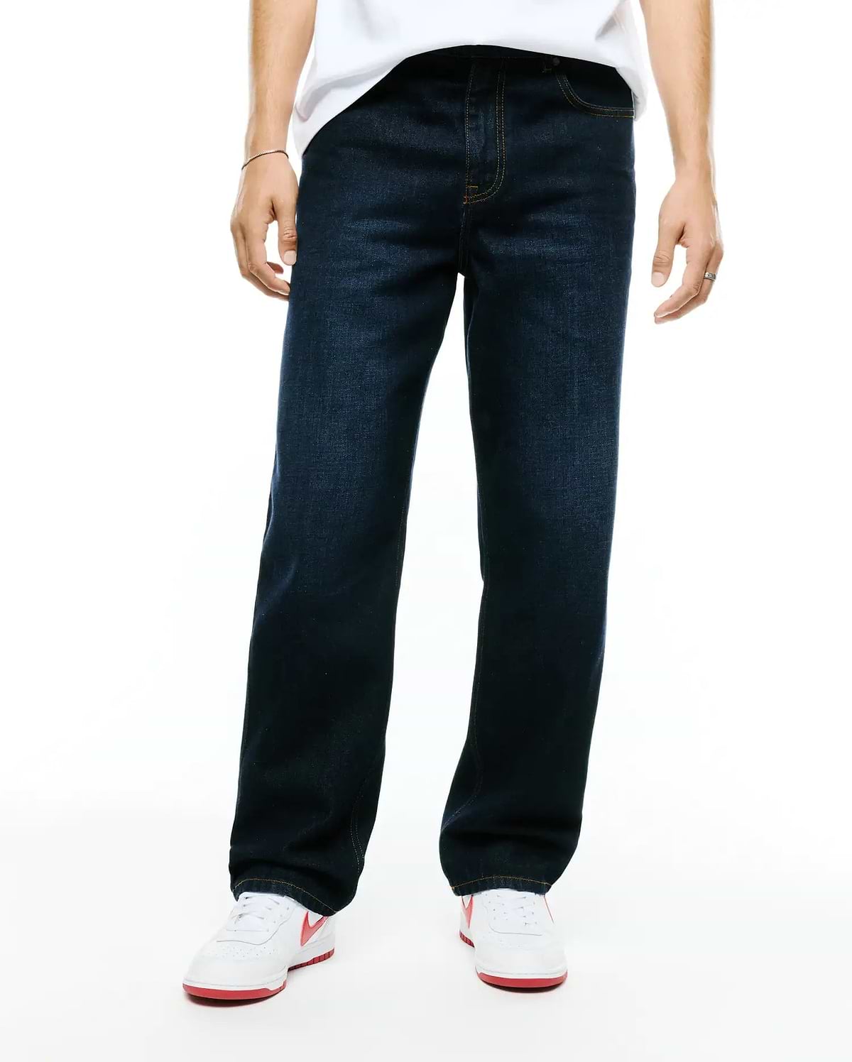 Men's Beck Oversized Denim Pants in dark indigo blue, featuring a relaxed straight leg fit, classic five-pocket styling, and contrasting orange stitching. (1)