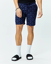 Mens Brad Linen Short 8 1/2, navy blue relaxed fit shorts with an all-over lighter blue Psycho Bunny skull and palm tree scalloped pattern, featuring a drawstring waist.