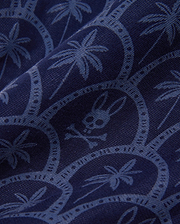 Mens Brad Linen Short 8 1/2 in navy blue, featuring a subtle lighter blue repeating print of palm trees, circular motifs, and the iconic Psycho Bunny skull logo on a woven linen fabric.
