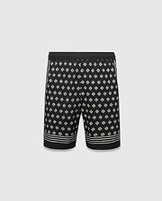 Mens Nick Tencel Short 7, black with an all-over white Psycho Bunny skull logo pattern, classic fit, smooth Tencel fabric, and white stripe accents on sides and hem.