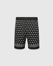 Mens Nick Tencel Short 7, black with an all-over white Psycho Bunny skull logo pattern, classic fit, smooth Tencel fabric, and white stripe accents on sides and hem.