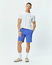 White classic fit jersey t-shirt featuring a small embroidered multi-color Psycho Bunny skull logo on the left chest, paired with vibrant blue MENS SHIRO TWILL SHORT.