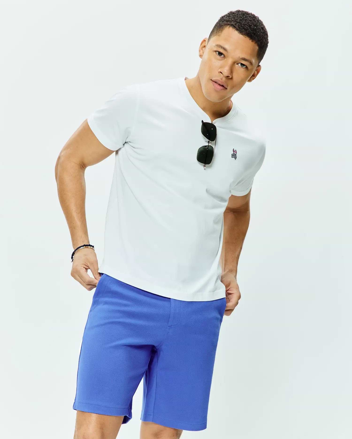 White classic fit crew neck jersey t-shirt featuring a small embroidered Psycho Bunny skull logo on the left chest, paired with vibrant royal blue MENS SHIRO TWILL SHORT.