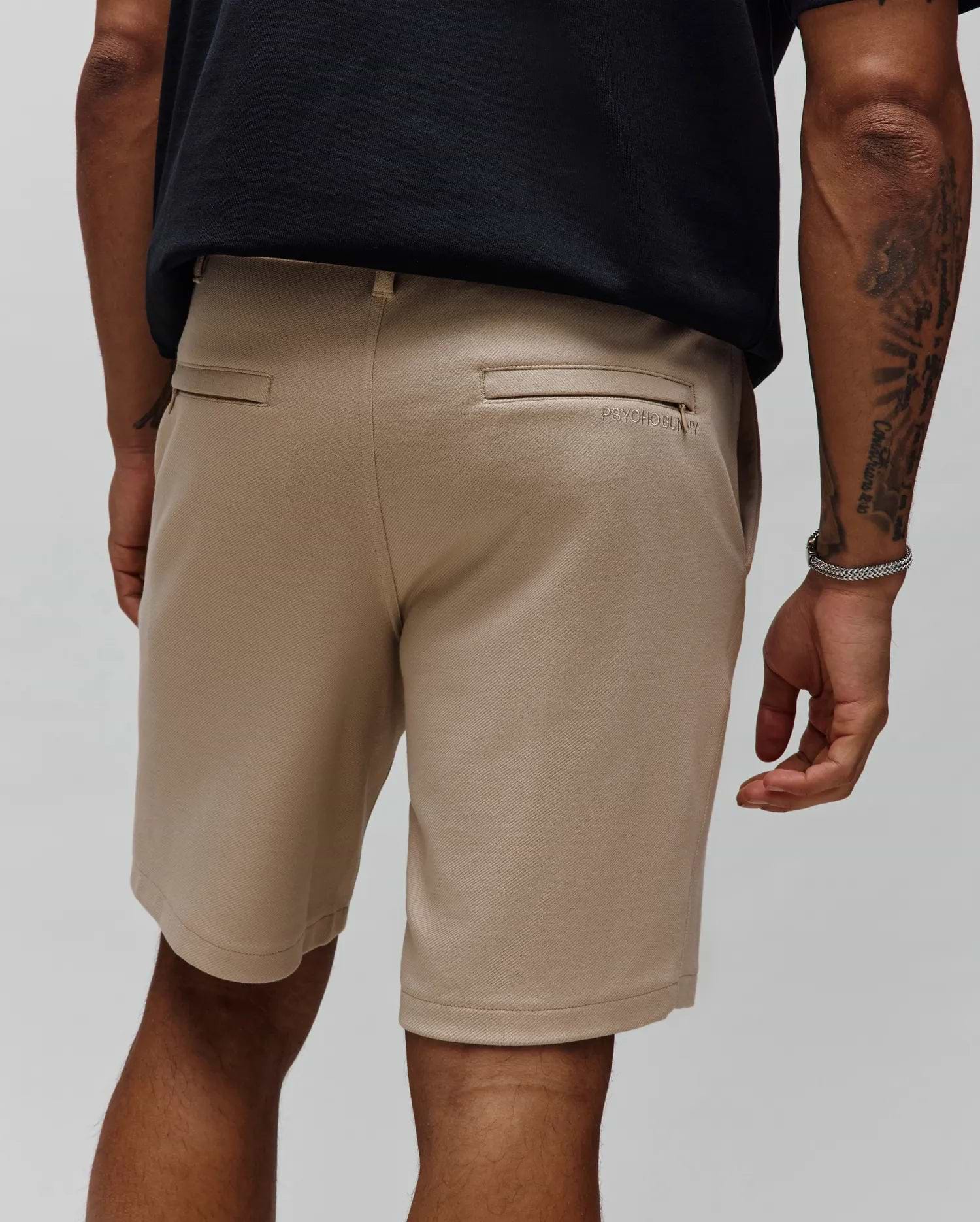 Khaki Mens Shiro Twill Short, a classic fit streetwear essential with a visible diagonal twill texture and subtle tonal embroidered Psycho Bunny text logo above the back right welt pocket.