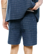 Mens Erik Raised Check Short, blue and dark blue relaxed fit shorts with a raised check texture, featuring two back patch pockets and a small white embroidered Psycho Bunny skull logo on the right pocket.