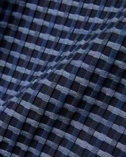 Mens Erik Raised Check Short featuring a textured, raised check pattern in varying shades of deep navy, medium blue, and light blue, creating a dynamic woven effect.