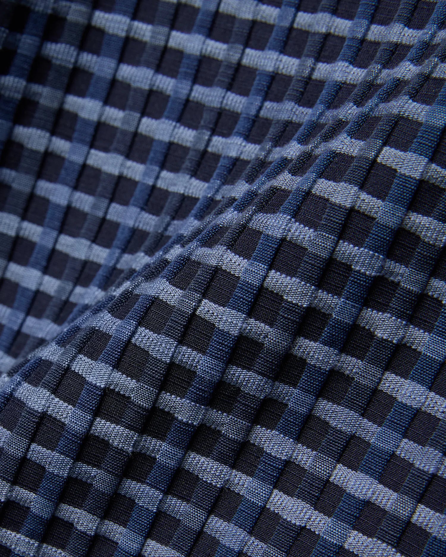 Mens Erik Raised Check Short featuring a textured, raised check pattern in varying shades of deep navy, medium blue, and light blue, creating a dynamic woven effect.