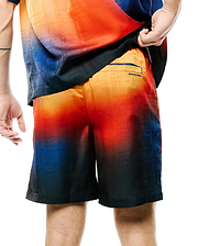 Mens Zander Jacquard Short, a relaxed fit short with a vibrant orange-red to deep blue gradient, featuring a subtle geometric jacquard pattern and a small Psycho Bunny text logo on the back right pocket.