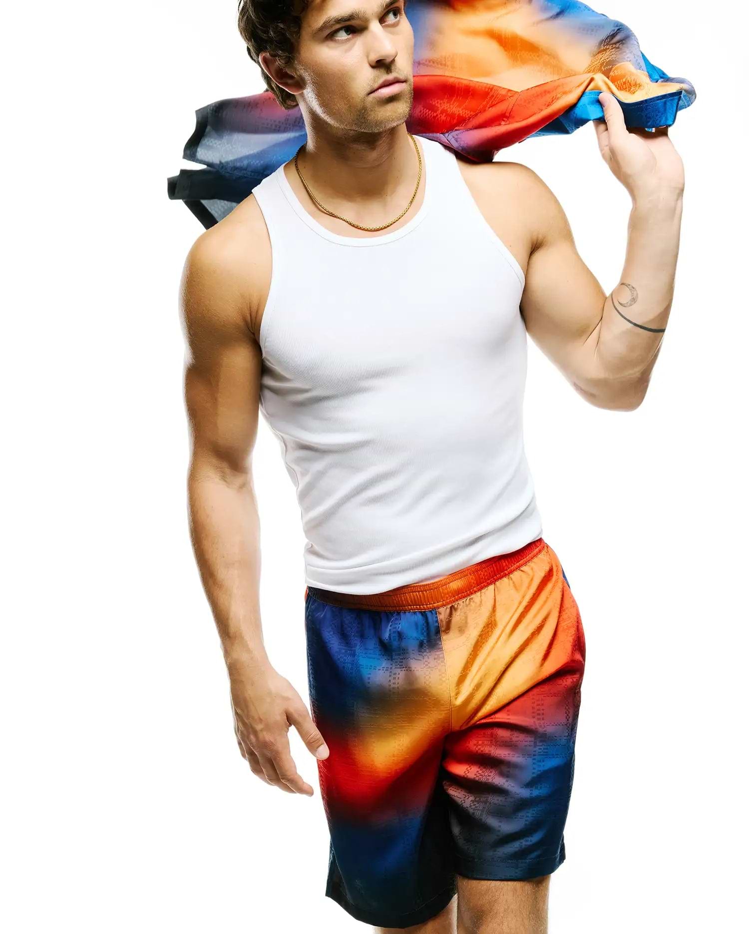 Mens Zander Jacquard Short featuring a vibrant orange, red, and blue gradient with a subtle geometric jacquard pattern, offering a relaxed fit in a smooth fabric, embodying Psycho Bunny's bold streetwear aesthetic.