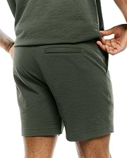 Mens Arlen Seersucker Short in dark olive green, featuring a classic fit, distinctive puckered seersucker texture, a subtle back welt pocket, and practical side pockets. (2)
