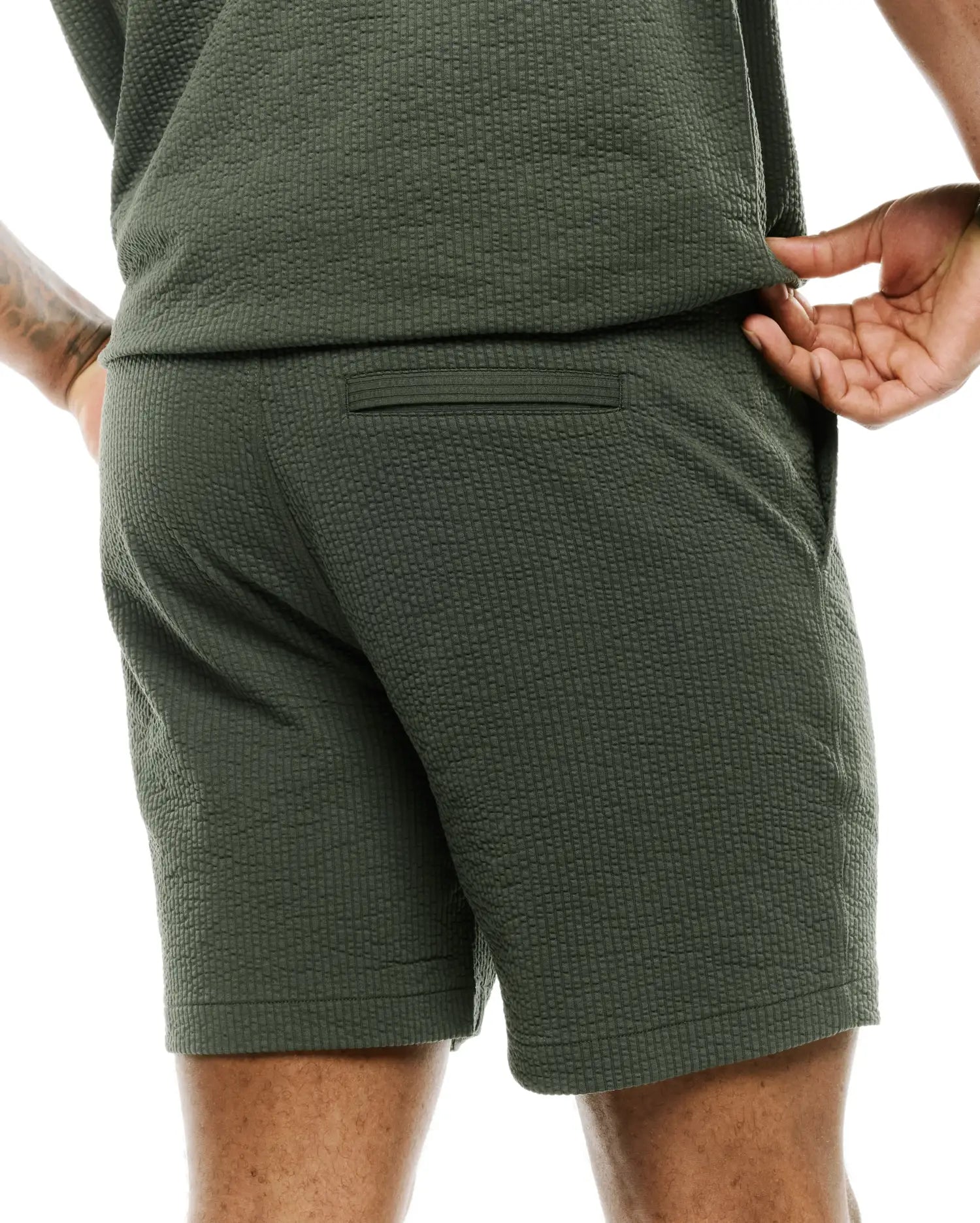 Mens Arlen Seersucker Short in dark olive green, featuring a classic fit, distinctive puckered seersucker texture, a subtle back welt pocket, and practical side pockets. (2)