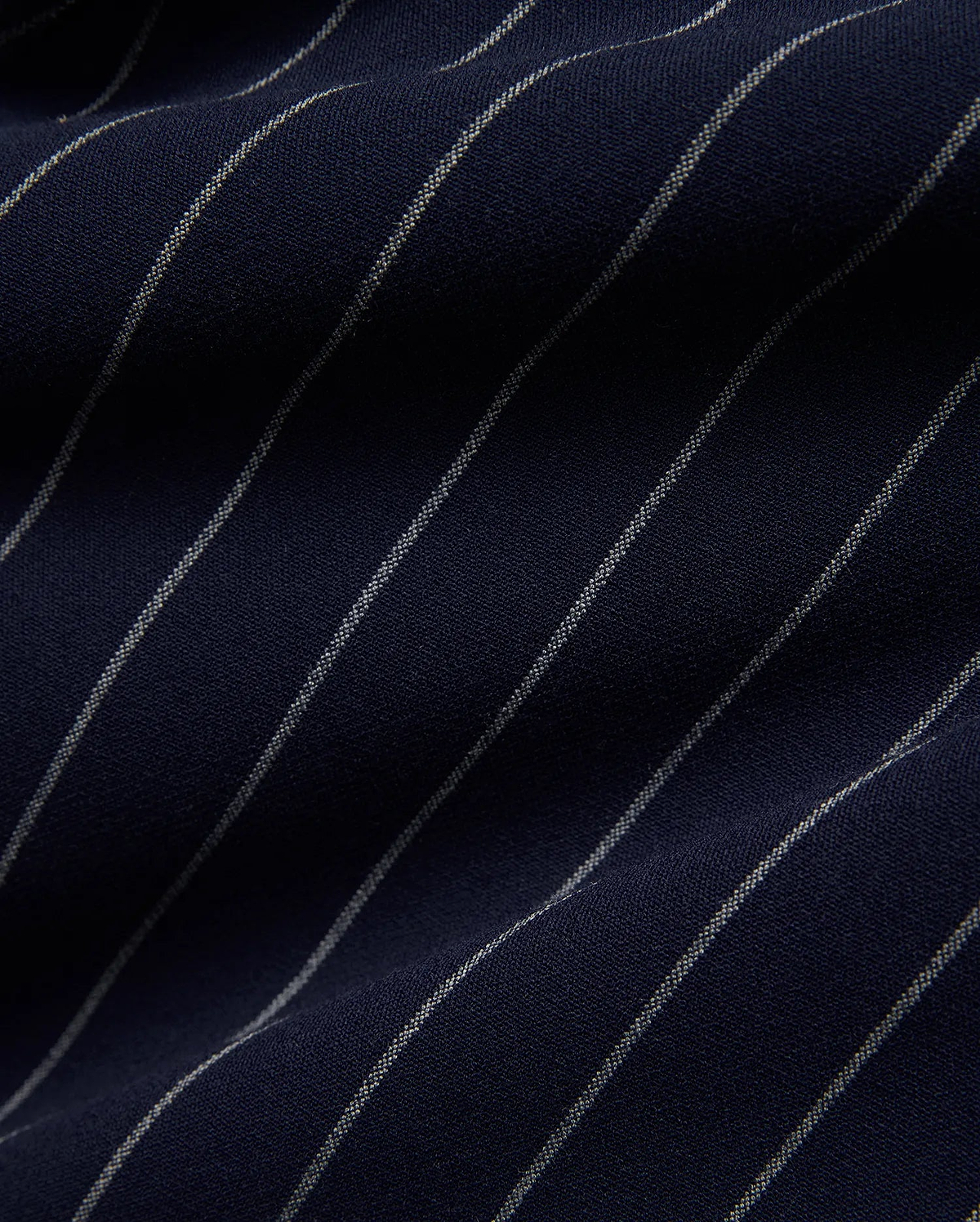 Mens Harland Double Weave Chalk Stripe Track Pant in deep navy blue, featuring fine, textured white chalk stripes woven into the fabric, highlighting its premium double weave texture. (6)