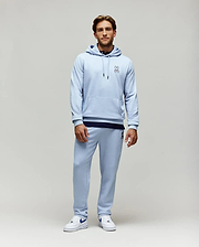 Light blue relaxed fit French terry hoodie with small embroidered Psycho Bunny skull logo on chest, kangaroo pocket, and matching Mens Timothy 4k Bunny Jogger with larger embroidered logo on thigh.
