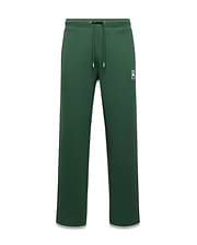 Mens Jaydon Track Pant, forest green, relaxed fit, smooth fabric, with a small white embroidered Psycho Bunny skull logo on the left thigh and a drawstring waist. (5)