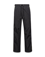 Mens Alder Nylon Colorblock Pant in black crinkled nylon, offering a relaxed fit with a drawstring waist and distinct olive green side stripes.