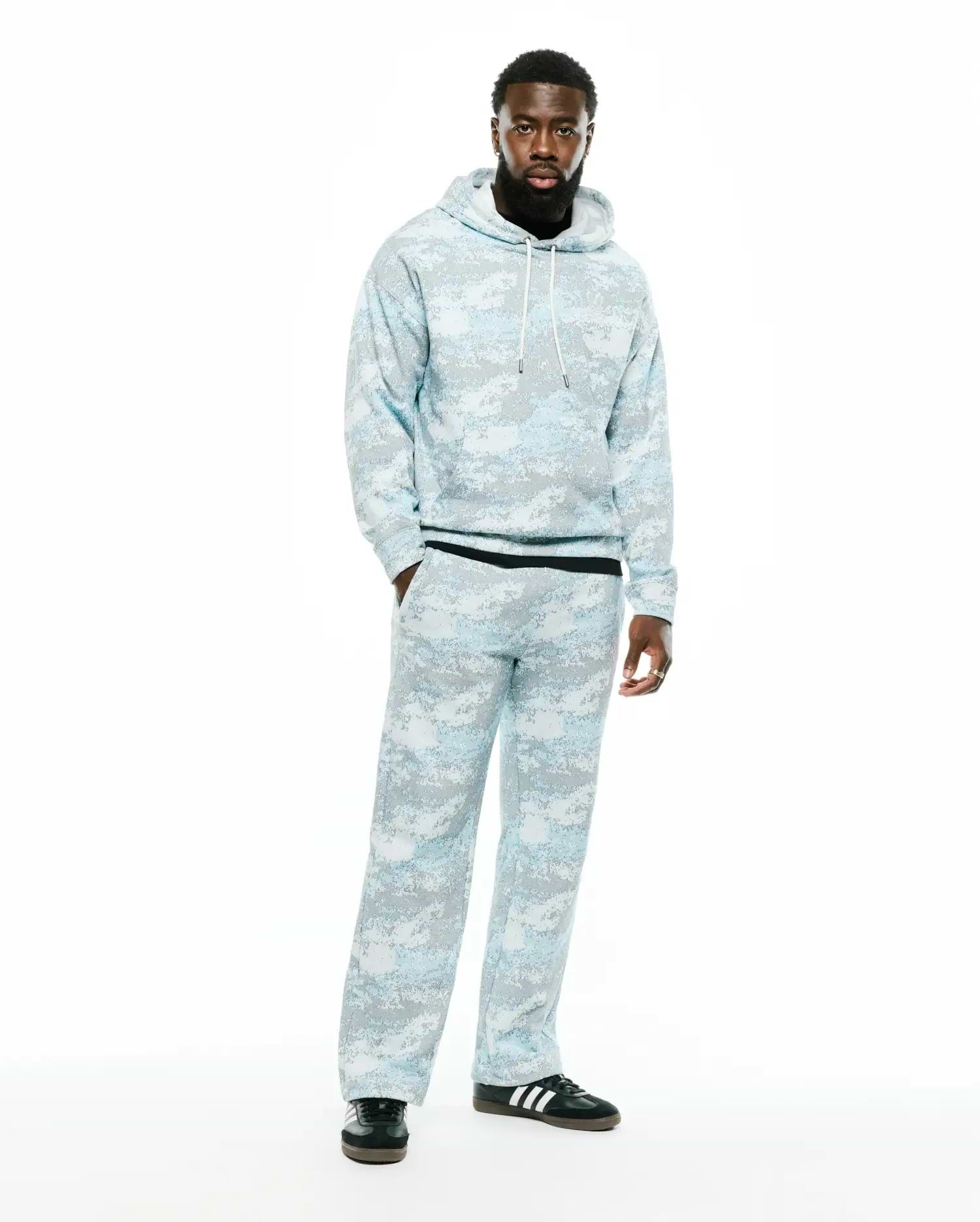 Relaxed fit light blue and grey digital camo French terry hoodie with white drawstrings and black ribbed hem, paired with matching Men's Alfie Graphic Sweatpants. (1)