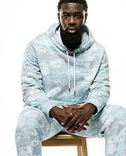 Relaxed fit light blue and grey pixelated Psycho Bunny hoodie and matching Men's Alfie Graphic Sweatpants, featuring a small white embroidered bunny skull logo on the chest. (4)