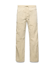 Mens Alder Nylon Pant in light beige with a crinkled nylon texture, featuring a relaxed straight-leg fit and an elasticated drawstring waist.