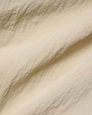 Mens Alder Nylon Pant in a sophisticated light beige hue, showcasing its premium, subtly textured and crinkled nylon fabric with a refined, fine weave, ideal for refined streetwear.