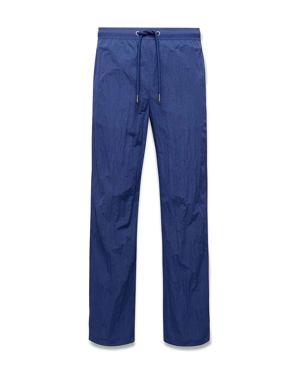 Mens Alder Nylon Pant in deep blue, featuring a relaxed straight leg fit, crinkled nylon fabric, and an elasticated drawstring waist with metallic tips. (5)
