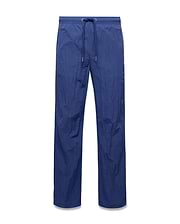 Mens Alder Nylon Pant in deep blue, featuring a relaxed straight leg fit, crinkled nylon fabric, and an elasticated drawstring waist with metallic tips. (5)