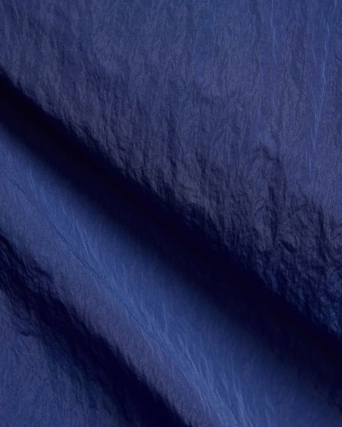 Mens Alder Nylon Pant in deep navy blue, featuring a crinkled nylon fabric with a subtle sheen, fine weave, and visible seam details. (6)
