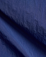 Mens Alder Nylon Pant in deep navy blue, featuring a crinkled nylon fabric with a subtle sheen, fine weave, and visible seam details. (6)