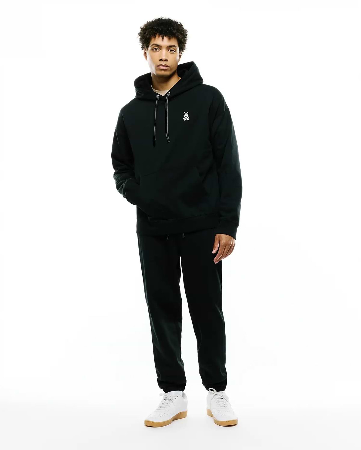 Deep green relaxed fit brushed fleece hoodie with white embroidered Psycho Bunny skull logo on left chest, white drawstrings, and kangaroo pocket. Paired with MENS TERRENCE BRUSHED FLEECE SWEATPANT.