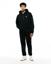 Deep green relaxed fit brushed fleece hoodie with white embroidered Psycho Bunny skull logo on left chest, white drawstrings, and kangaroo pocket. Paired with MENS TERRENCE BRUSHED FLEECE SWEATPANT.