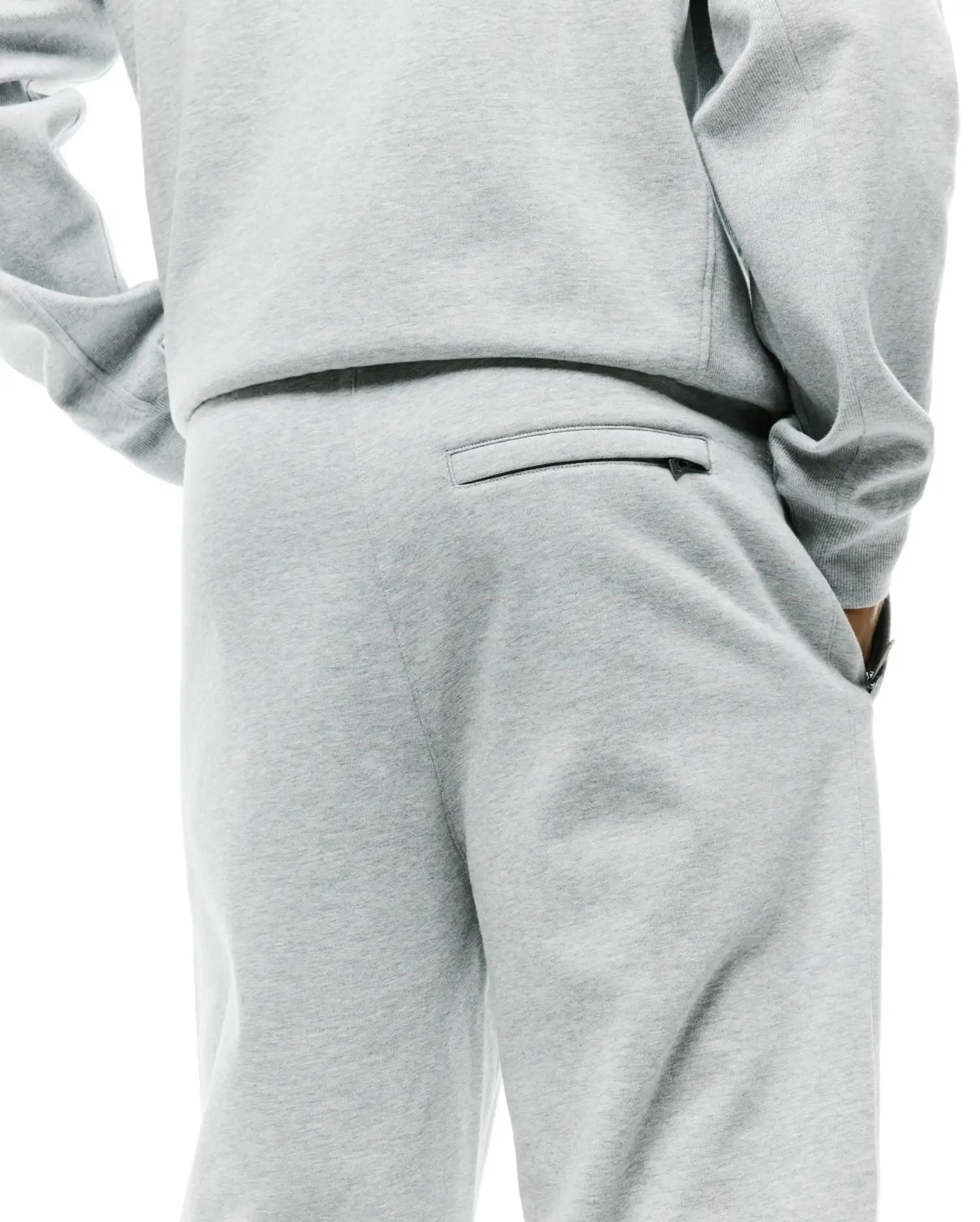 Mens Terrence Brushed Fleece Sweatpant in light grey marl, offering a relaxed fit, soft brushed fleece texture, a zippered back pocket, and convenient side pockets.