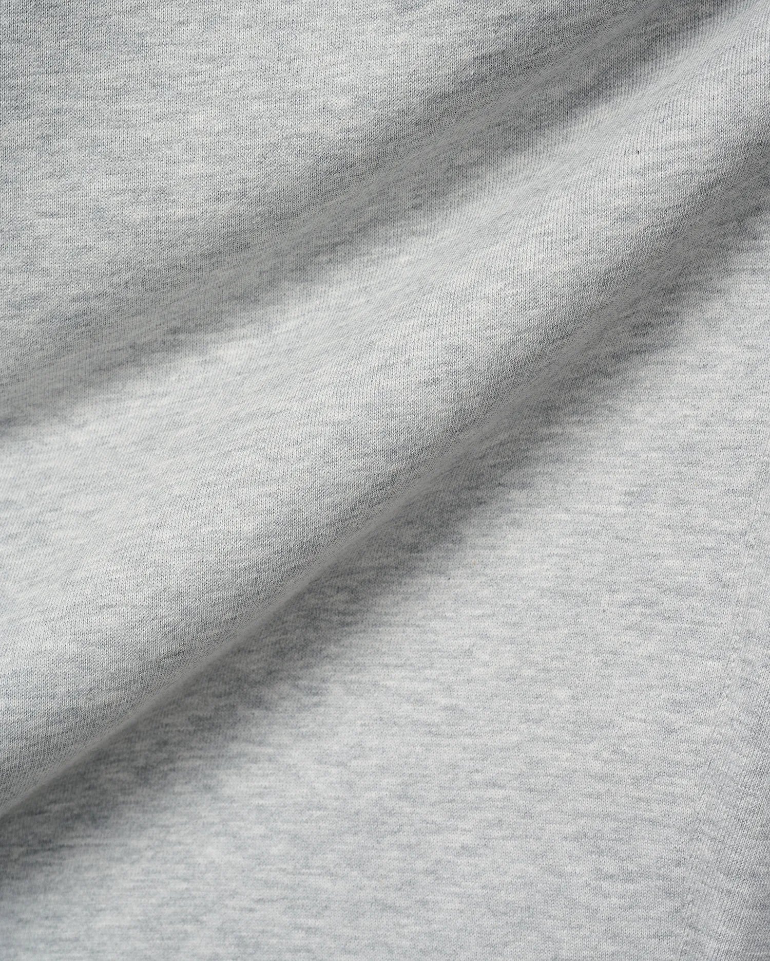 Mens Terrence Brushed Fleece Sweatpant, featuring a soft, light grey heathered brushed fleece fabric with a subtle knit texture and gentle folds.
