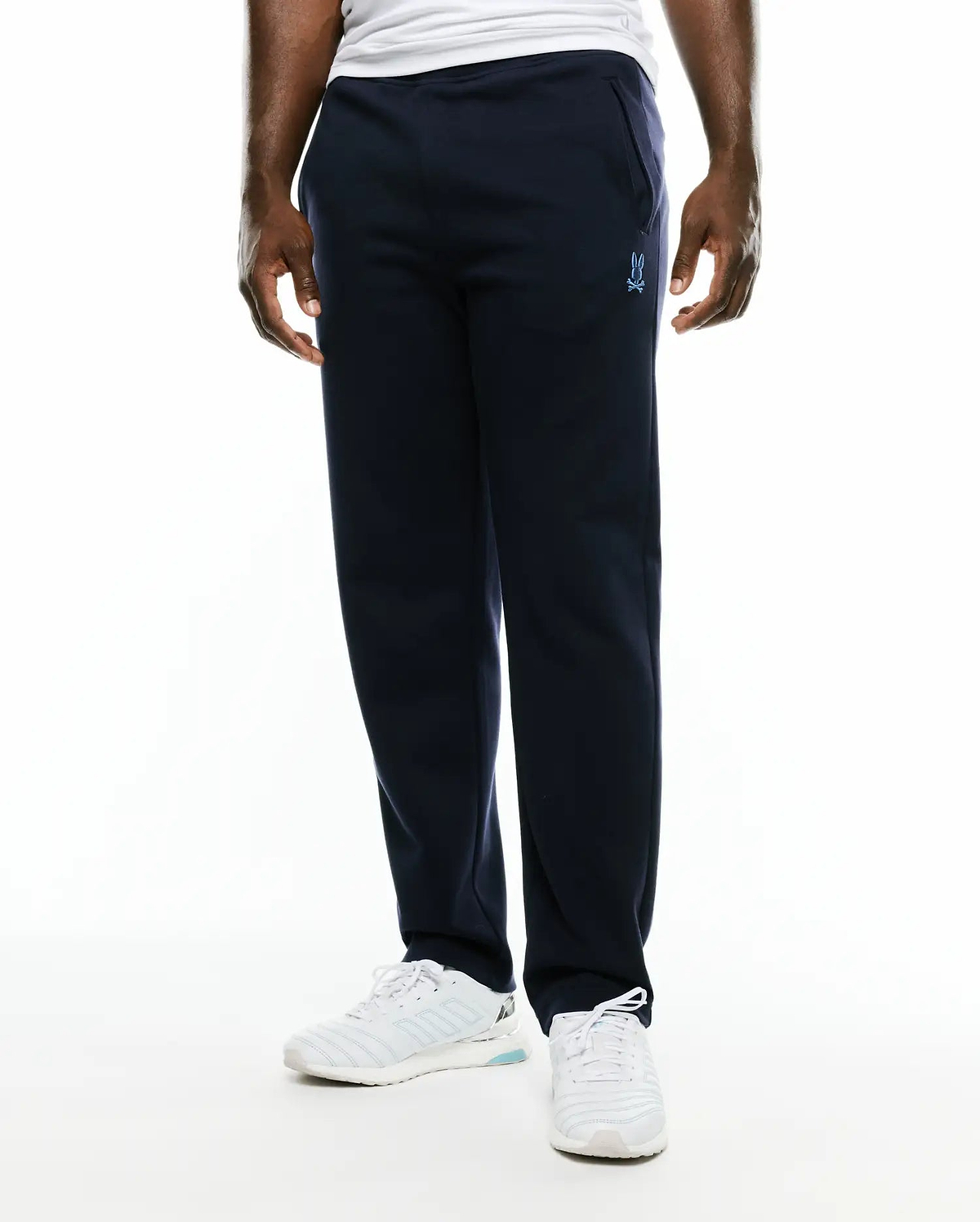 Men's Jacques Pique Track Pants in navy, featuring a relaxed fit and a small, light blue embroidered Psycho Bunny skull logo on the left thigh. (2)