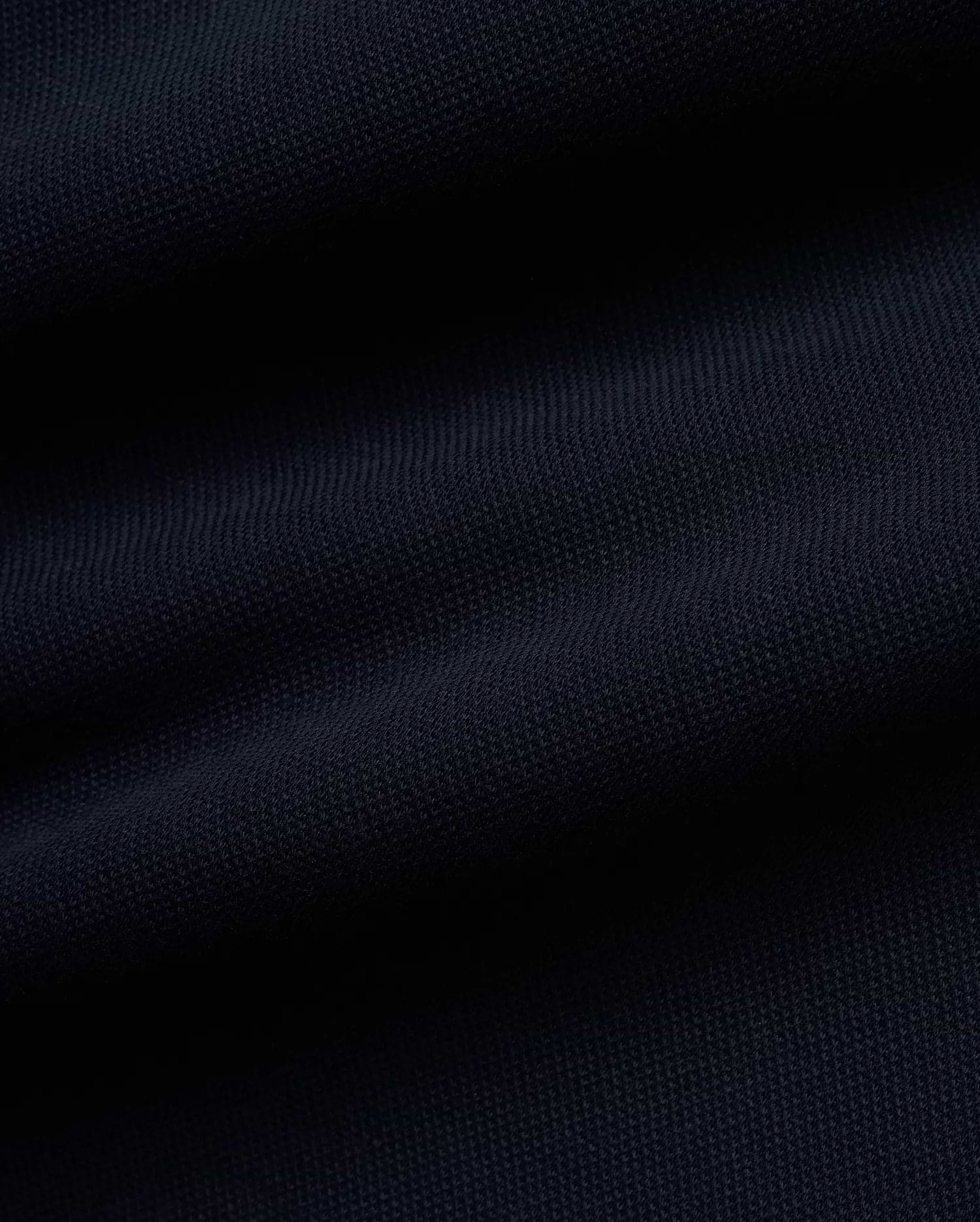 Rich, deep navy blue Pique fabric for the premium MEN'S JACQUES PIQUE TRACK PANTS, featuring a distinct, textured weave indicative of refined streetwear quality. (6)