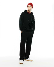 Black relaxed fit French terry hoodie with large tonal Psycho Bunny skull logo, paired with Men's Johan Straight-Leg Sweatpants and a red knit beanie featuring an embroidered bunny skull. (1)