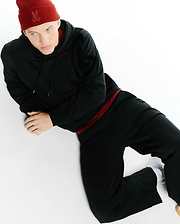 Red ribbed Psycho Bunny beanie with tonal skull logo, black classic fit French terry hoodie with red drawstring and subtle sleeve logo, paired with black Men's Johan Straight-Leg Sweatpants. (4)