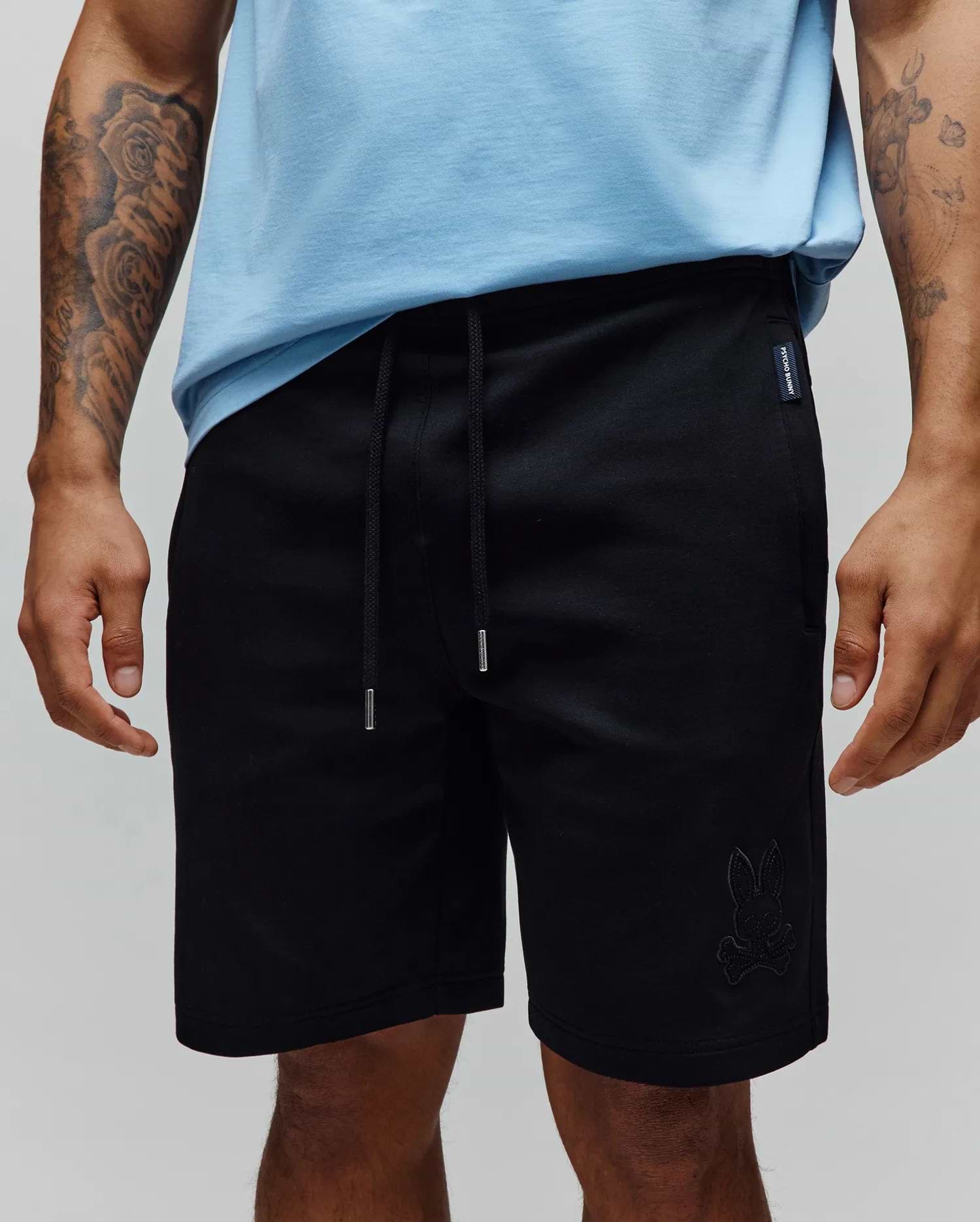 Black Mens Barry Short, relaxed fit jersey shorts featuring a drawstring waist with silver tips, a small tonal embroidered bunny skull logo on the right leg, and a woven Psycho Bunny tag on the left hip.