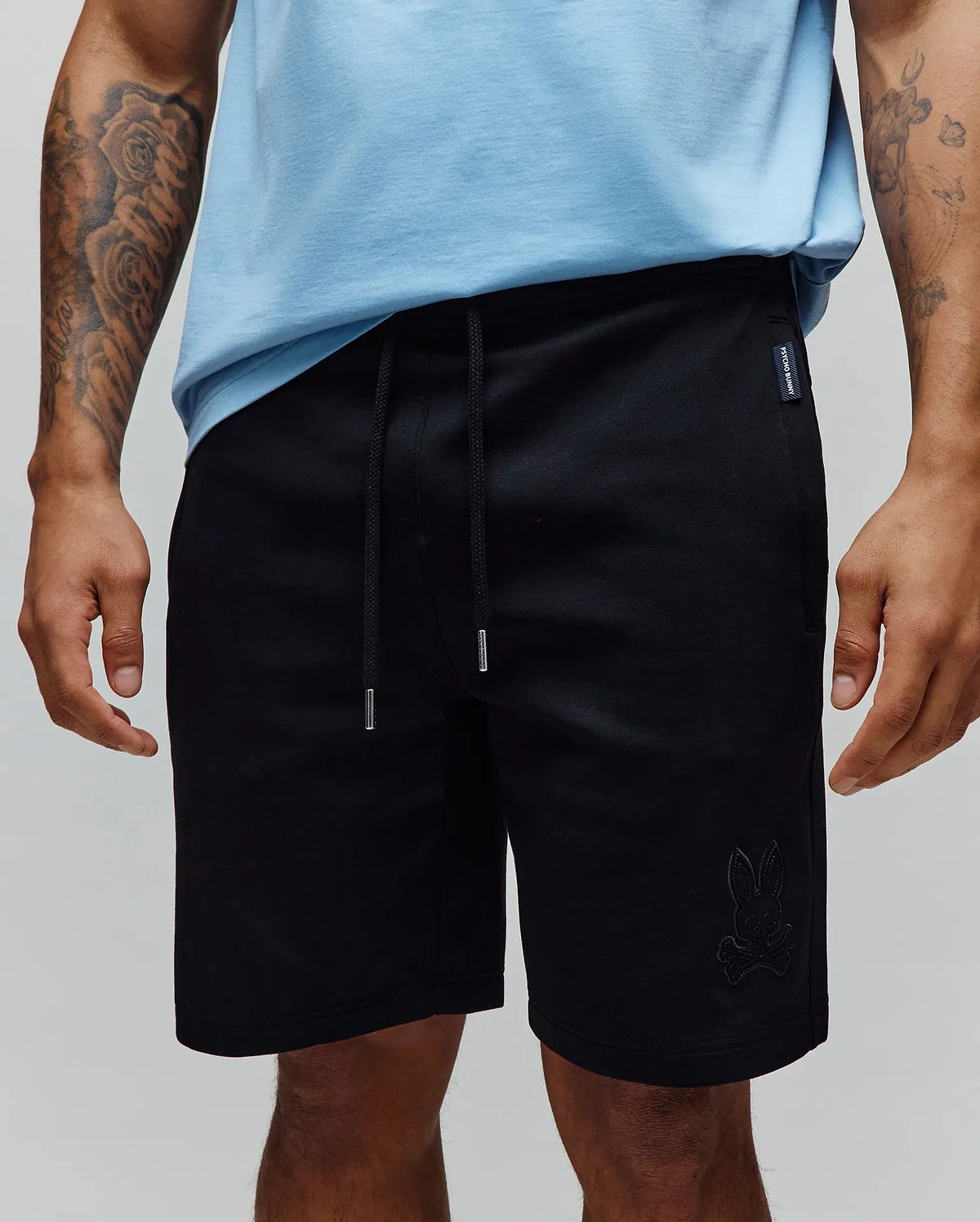Black Mens Barry Short, relaxed fit jersey shorts featuring a drawstring waist with silver tips, a small tonal embroidered bunny skull logo on the right leg, and a woven Psycho Bunny tag on the left hip.