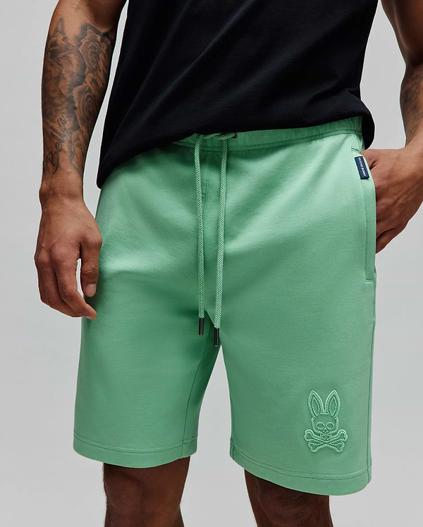 Mens Barry Short in mint green, relaxed fit, soft french terry, drawstring waist with dark tips, large tonal embroidered bunny skull on right leg, and small navy Psycho Bunny tag on left pocket.