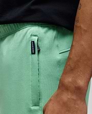 Mens Barry Short in mint green, featuring a relaxed fit, smooth jersey fabric, and a black zippered side pocket with a small woven Psycho Bunny tag.