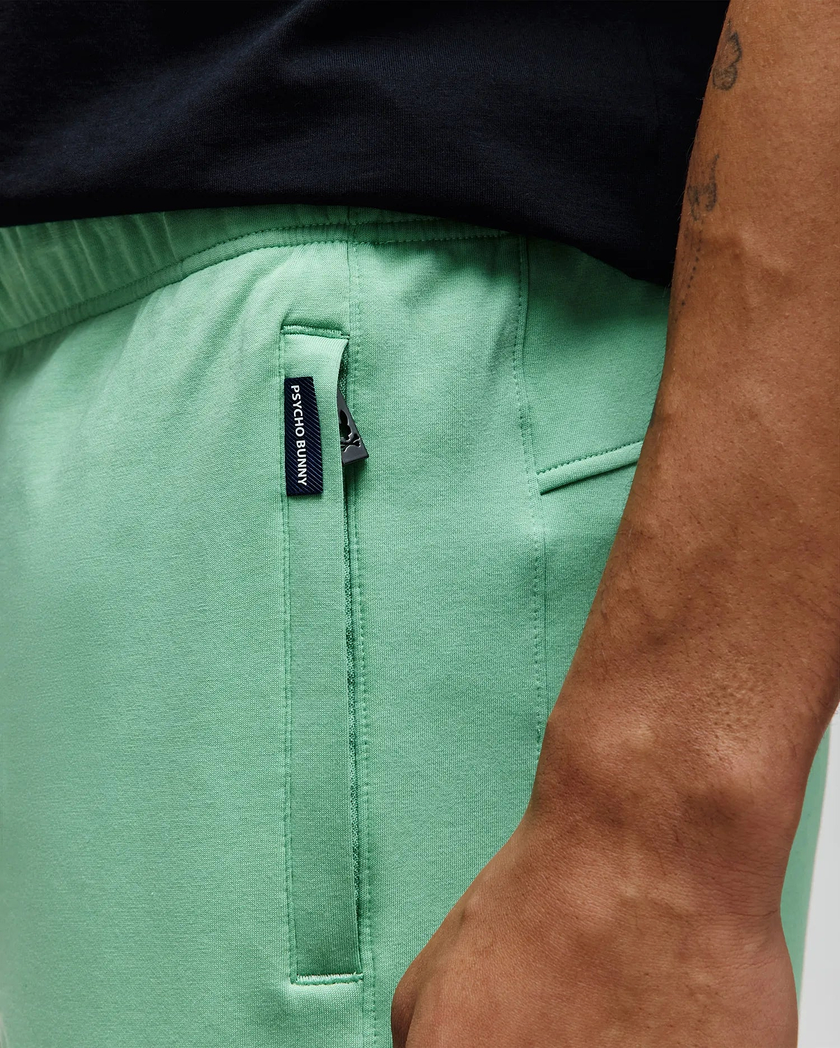 Mens Barry Short in mint green, featuring a relaxed fit, smooth jersey fabric, and a black zippered side pocket with a small woven Psycho Bunny tag.