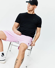 Black classic fit jersey t-shirt with tonal Psycho Bunny skull on chest; light pink Mens Keith Short 8 relaxed pique shorts with purple Psycho Bunny skull on thigh.
