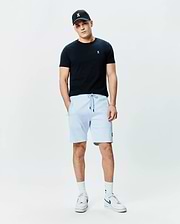 Black jersey t-shirt with white Psycho Bunny logo on chest, light blue Mens Keith Short 8 French terry shorts with black drawstrings and bunny logo on thigh, plus a black cap with white bunny skull.