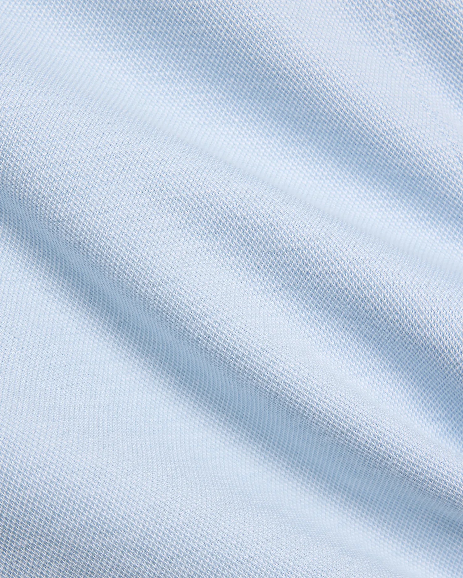 Mens Keith Short 8, showcasing a close-up of its premium light blue pique knit fabric, featuring a subtle, breathable texture, embodying Psycho Bunny's refined streetwear aesthetic.
