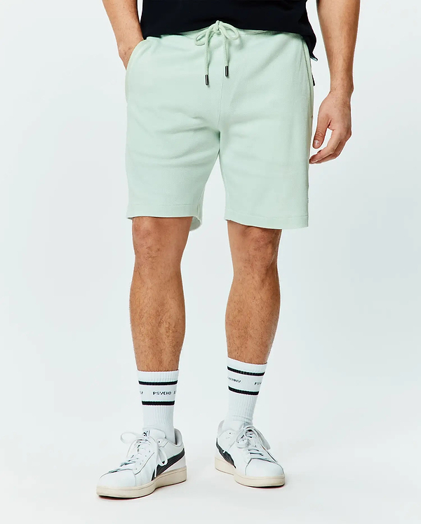 Mens Keith Short 8, a relaxed fit light mint green pique knit short with an adjustable drawstring waist featuring black metal tips and subtle side pockets.