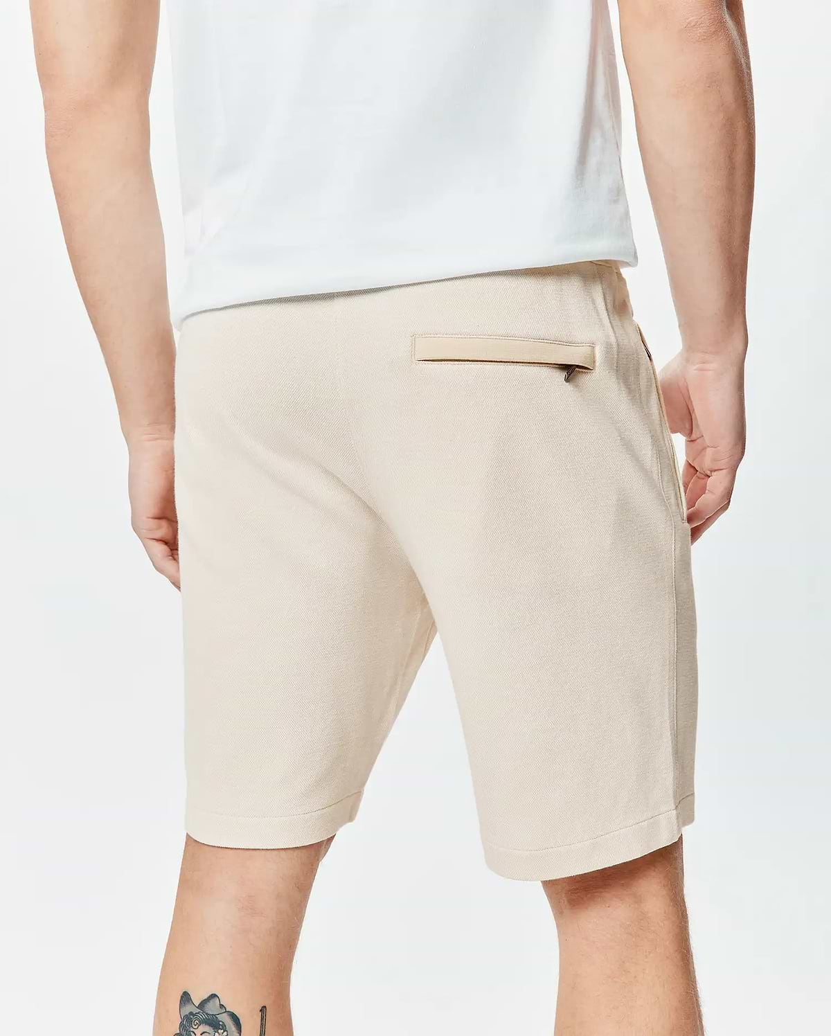 Mens Keith Short 8, light beige textured knit shorts with a classic fit, featuring a rear welt pocket with a dark zipper and side pockets.