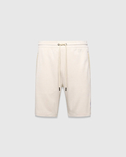 Mens Keith Short 8, cream pique knit shorts with a relaxed fit, featuring a drawstring waist, side pockets, and a small embroidered lavender Psycho Bunny skull logo on the left leg.