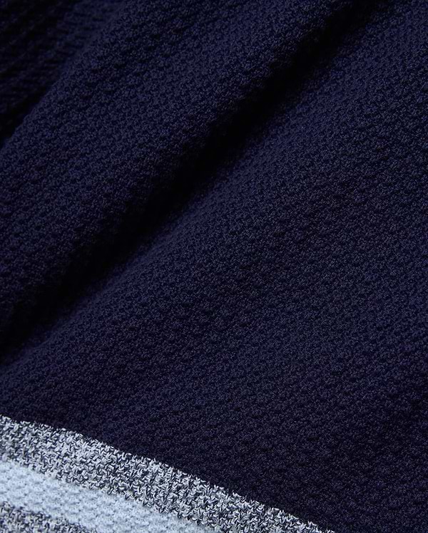 Mens Giles Knit Short 7, crafted from a deep navy textured knit fabric, detailed with a contrasting light blue and white striped hem for a refined streetwear aesthetic.