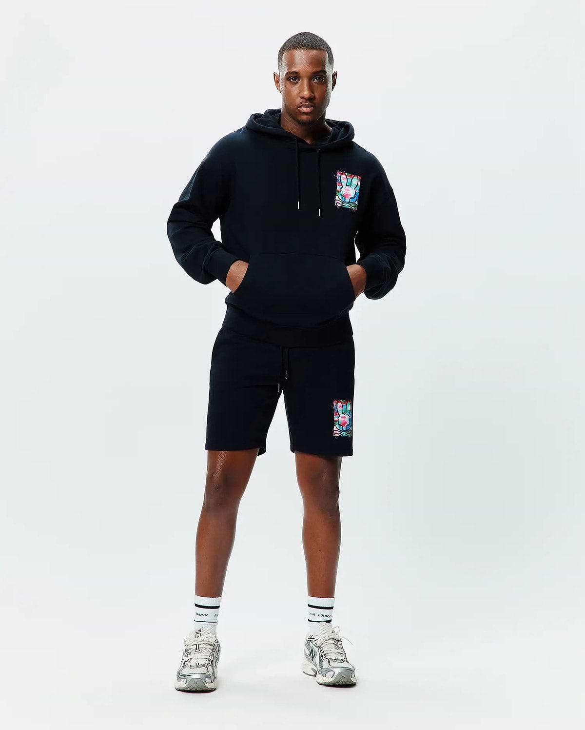 Black relaxed fit French terry hoodie with a large colorful abstract bunny skull graphic on the left chest, paired with matching Mens Isaac Print Short with the same graphic on the left thigh.