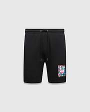 Mens Isaac Print Short, black classic fit jersey shorts featuring a drawstring waist and a large, vibrant multi-color paint splatter Psycho Bunny skull logo graphic on the lower left leg.