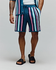 Mens Cliff Knit Short, a relaxed fit knit short with bold teal, pink, white, light blue, and navy vertical stripes, featuring a small embroidered Psycho Bunny skull logo on the lower left leg and a drawstring waist. (3)